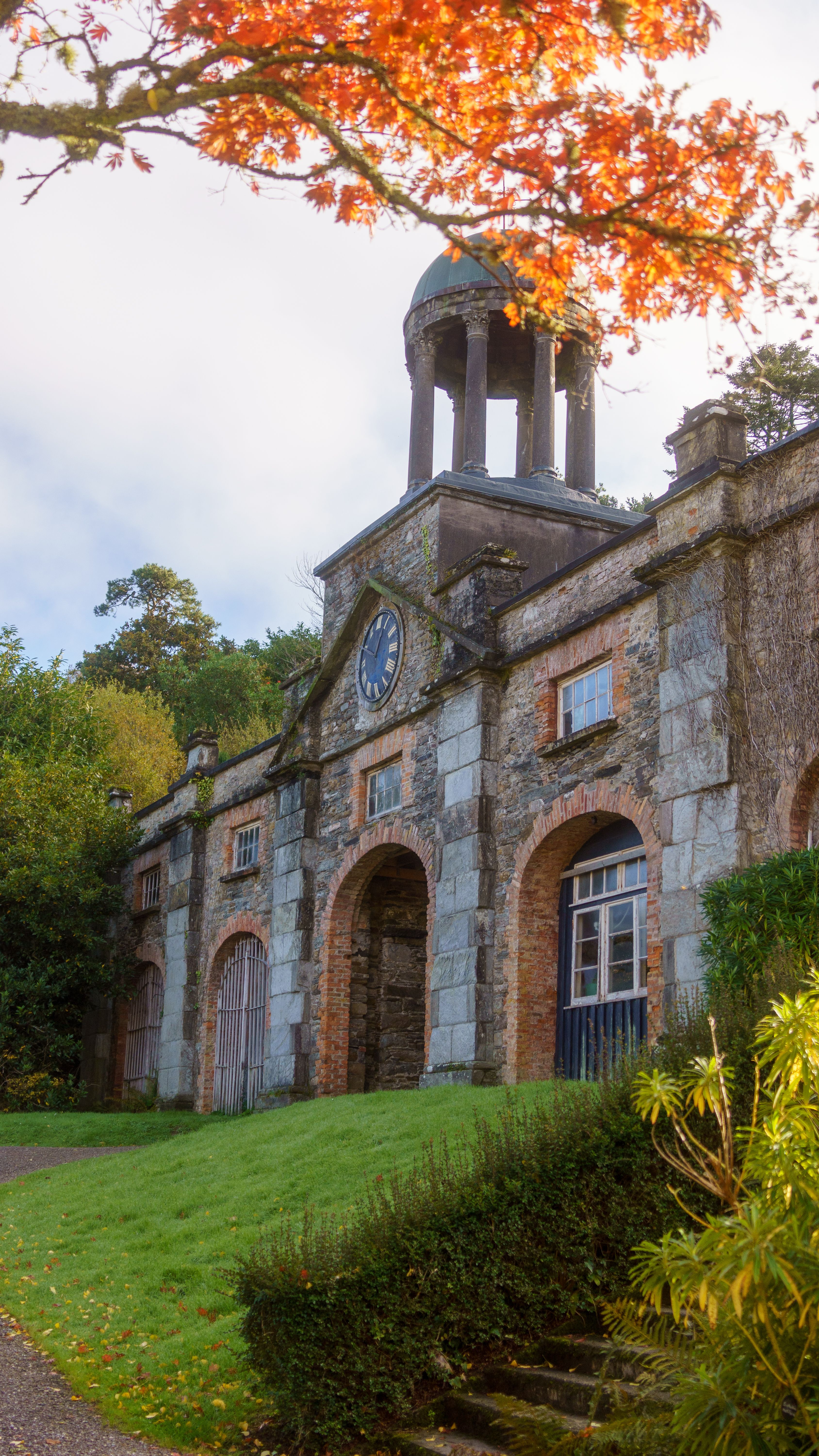 Beautiful autumn scene featuring a historic stone building with a clocktower in Ireland.