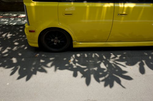 Free Yellow Vehicle Parked on Pavement Stock Photo