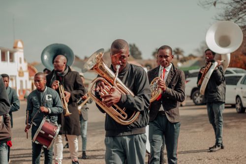 Free A vibrant street parade featuring musicians playing brass instruments in an energetic performance. Stock Photo