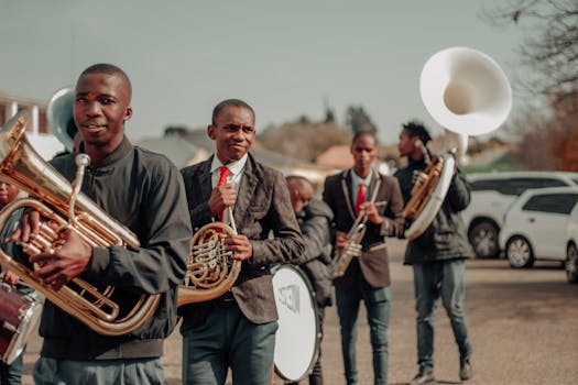 Group of young musicians playing brass instruments in an outdoor street parade.