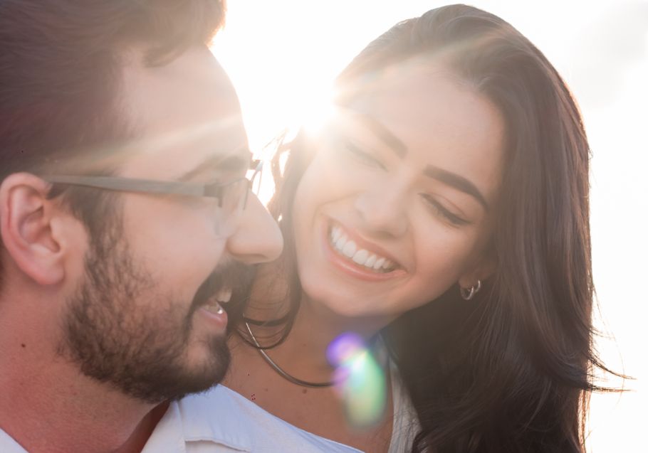 couple enjoying coffee at outdoor cafe while using dating app