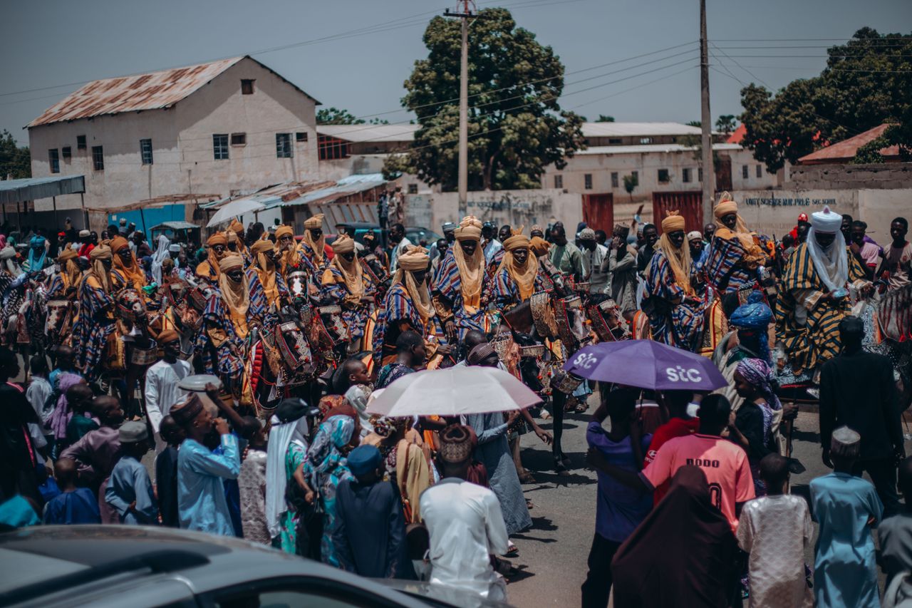 colorful parade with riders in traditional attire celebrating nigerian