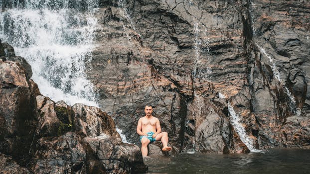A man enjoys the natural beauty of a waterfall in Artvin, Türkiye. Perfect escape.