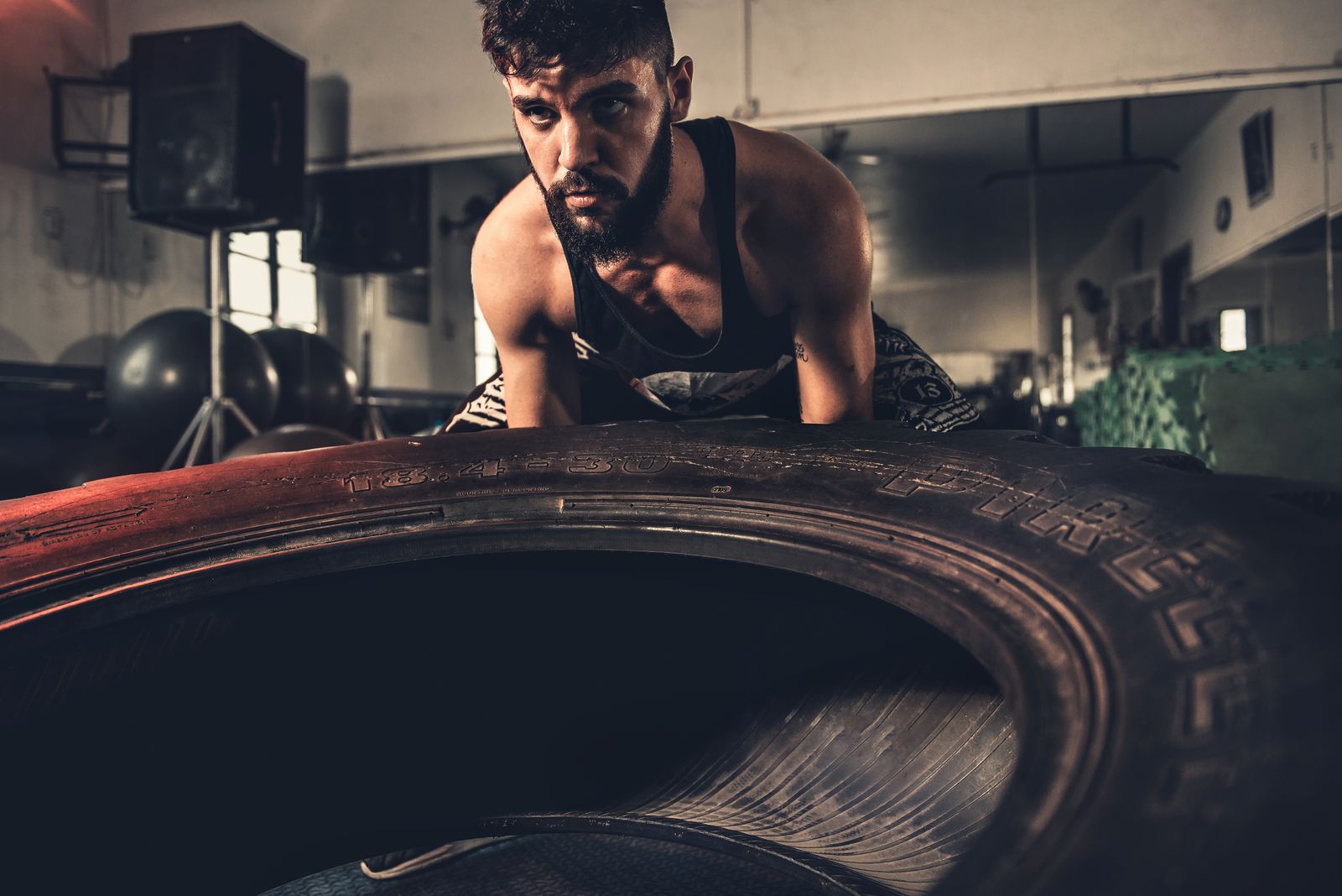 Person lifting weights in a gym, representing conventional exercise compared to yoga
