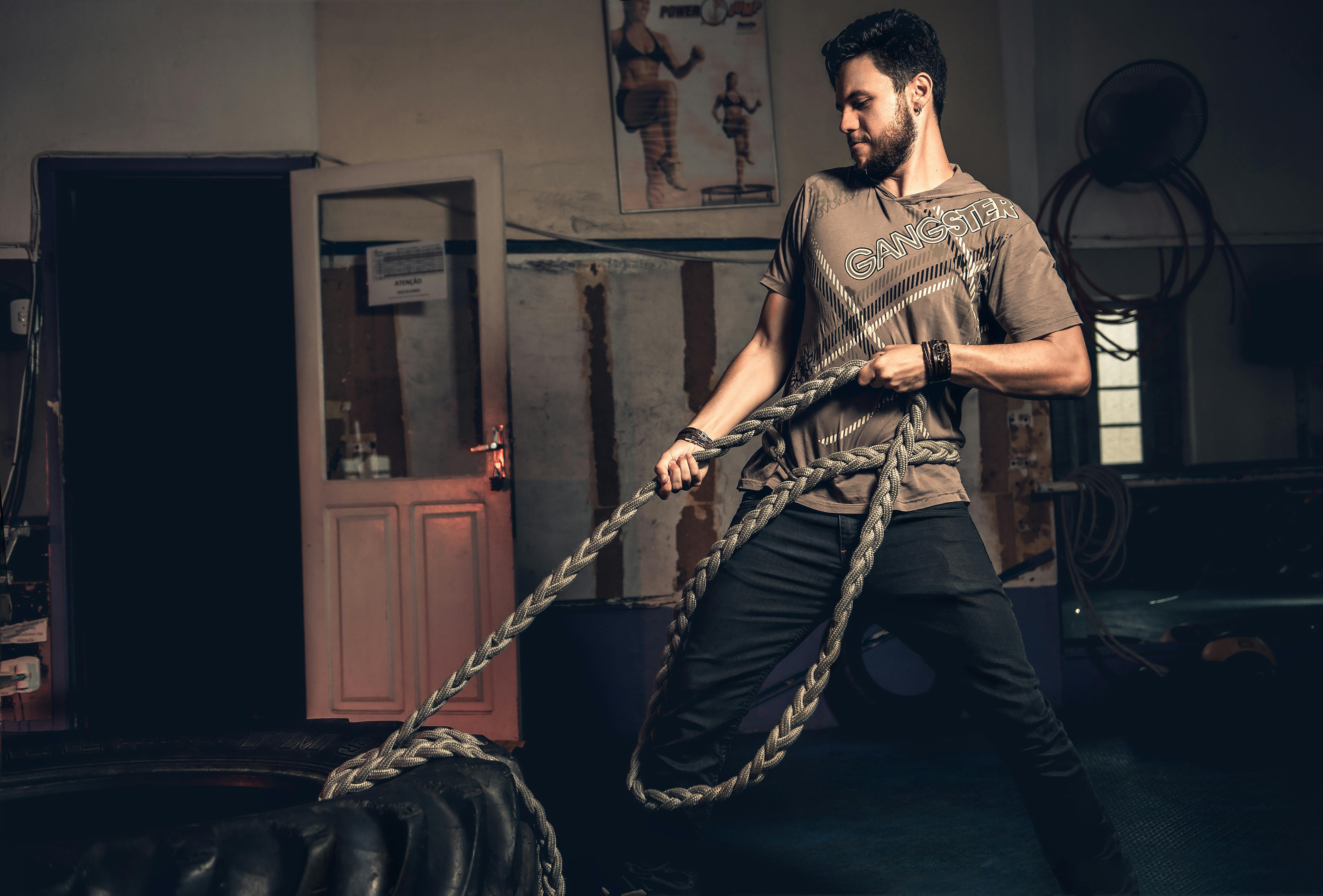 Man Pulling Rope Tied on a Tire · Free Stock Photo