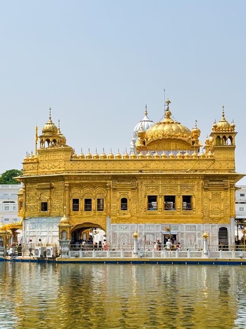 Free Stunning view of the Golden Temple reflecting in water on a sunny day in Amritsar, India. Stock Photo