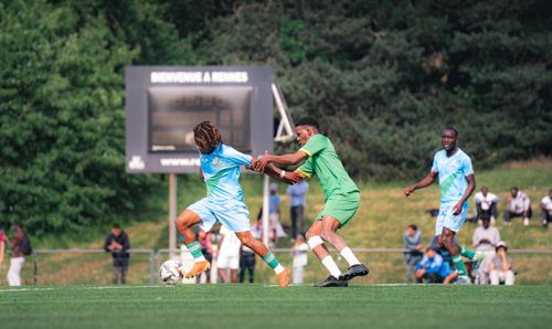 Free Players compete in a thrilling soccer match at Rennes, showcasing sportsmanship. Stock Photo