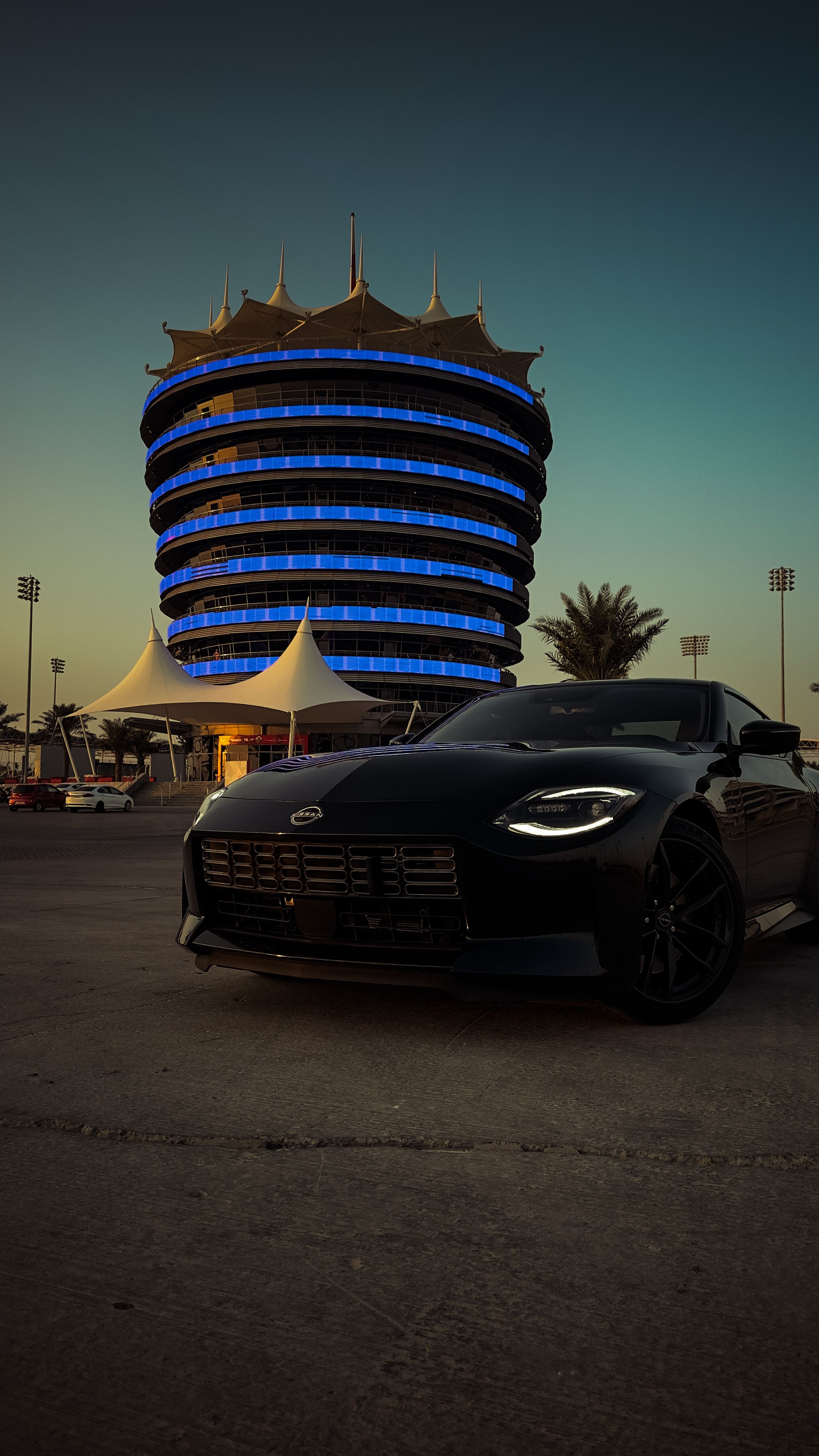 Sleek Car in Front of Bahrain International Circuit · Free Stock Photo