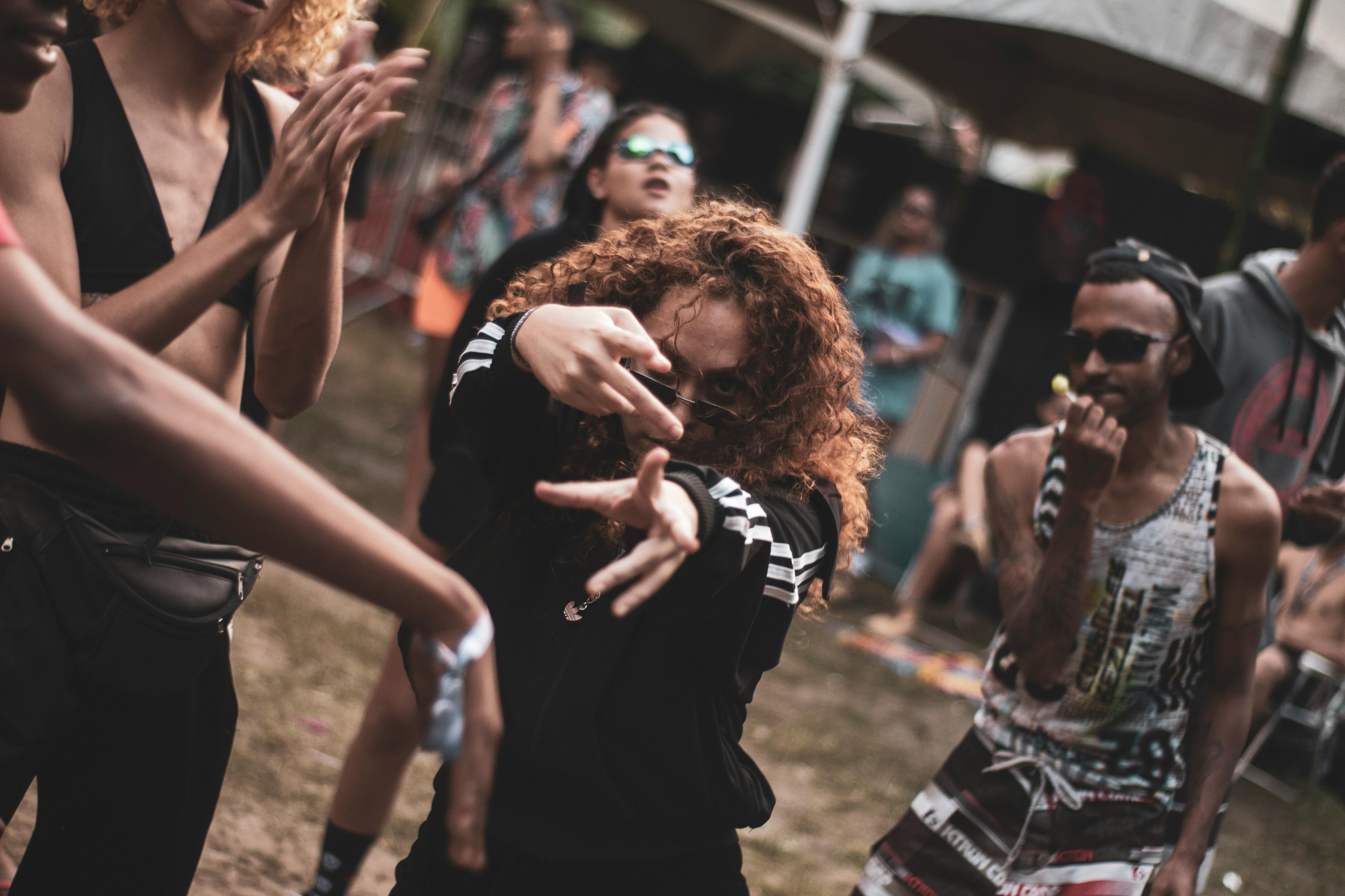 Vibrant outdoor dance party scene with diverse group of young adults enjoying music in Recife, Brazil.