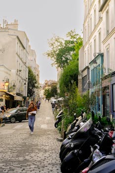 A picturesque street scene in Montmartre, Paris, showcasing classic architecture and vibrant life.