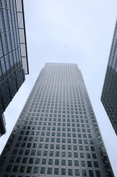 Upward view of a modern skyscraper in London's financial sector, showcasing architecture.