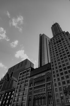 A striking black and white view of Chicago skyscrapers with intricate architectural details against the sky.