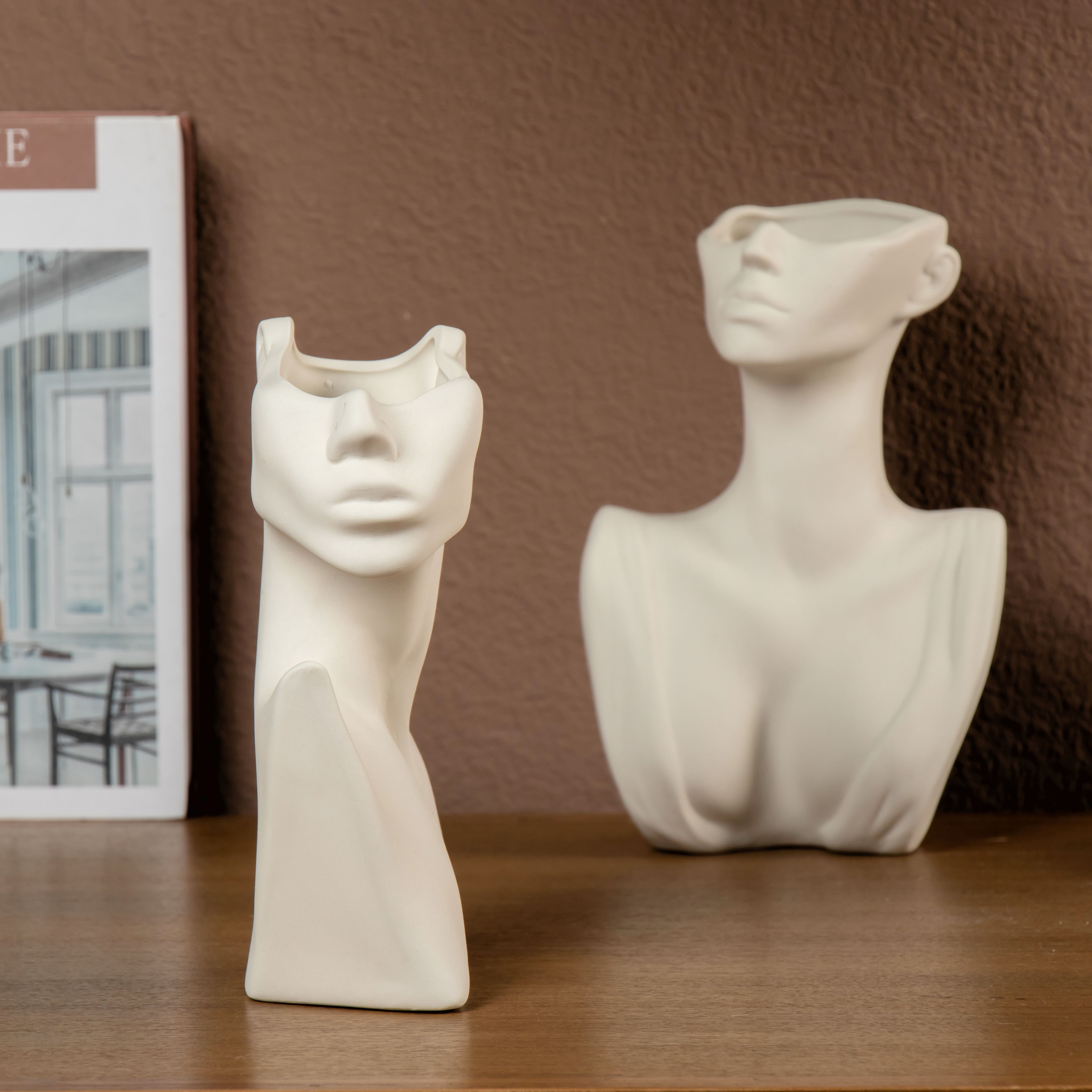 Minimalist abstract bust sculptures on a shelf — photo by BOB oj on Pexels