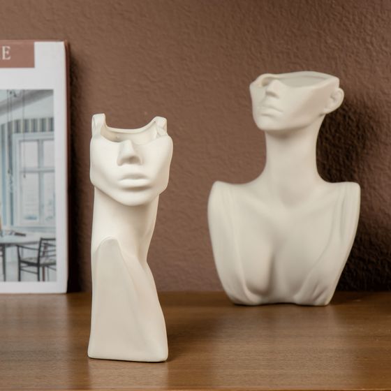 Minimalist abstract bust sculptures on a shelf — photo by BOB oj on Pexels