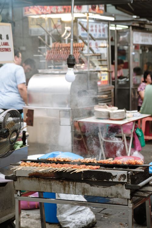 Street Food Stall with Grilled Skewers in Market · Free Stock Photo