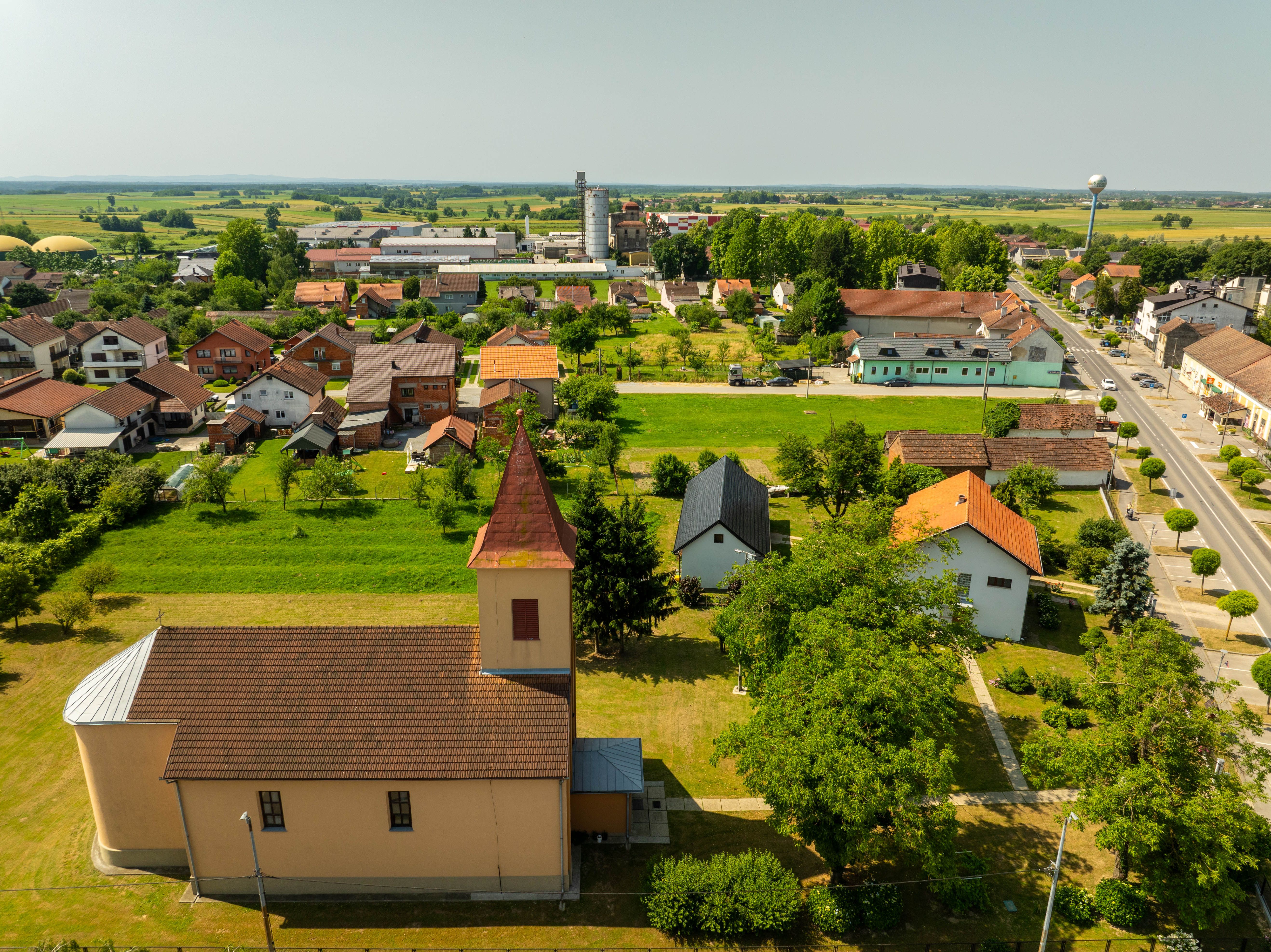 Scenic aerial view of Hercegovac village displaying traditional architecture and lush greenery.