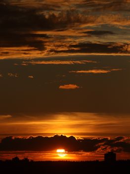 Capture a breathtaking sunset view over Vilnius with vibrant, dramatic clouds and silhouette skyline.