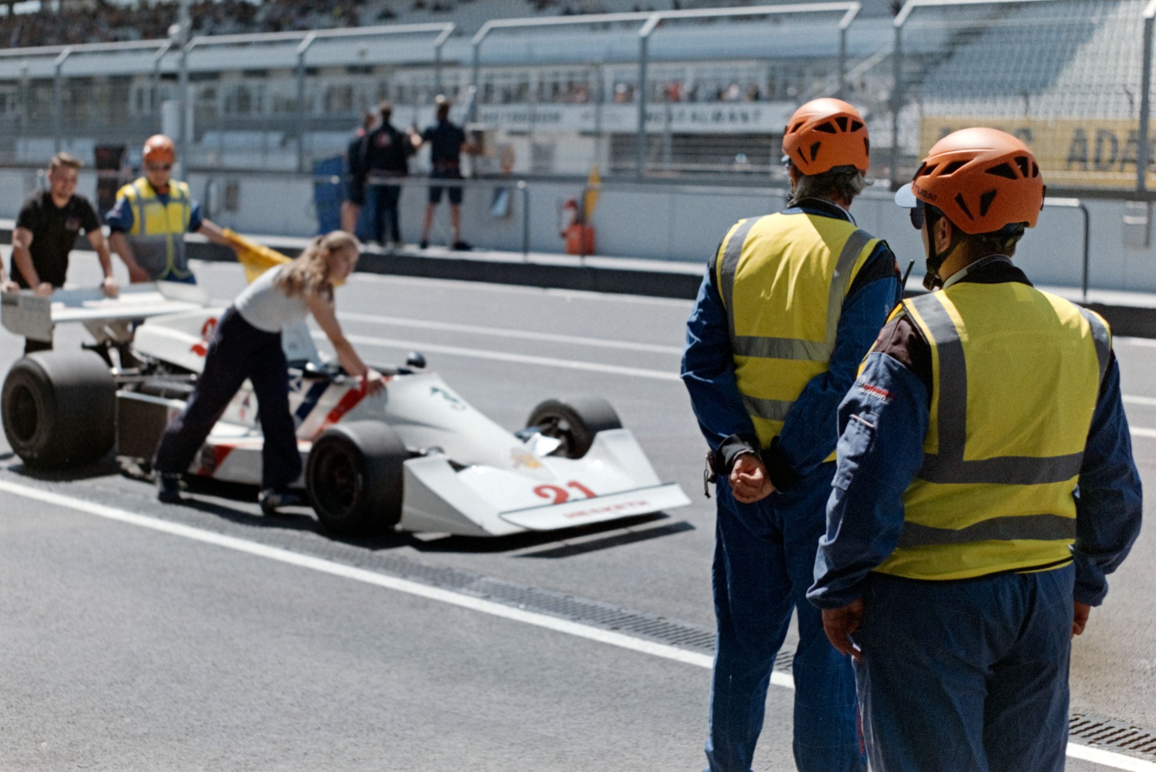 Team Racing Course Race Car Entering Pit Stop during Motorsport Event · Free Stock Photo