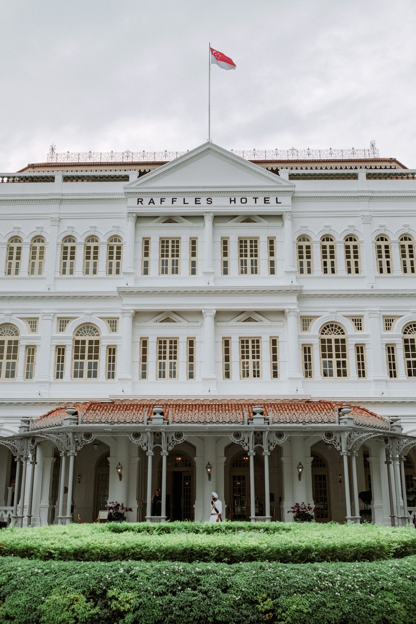 The colonial-era facade of Raffles Hotel Singapore, seen from the street