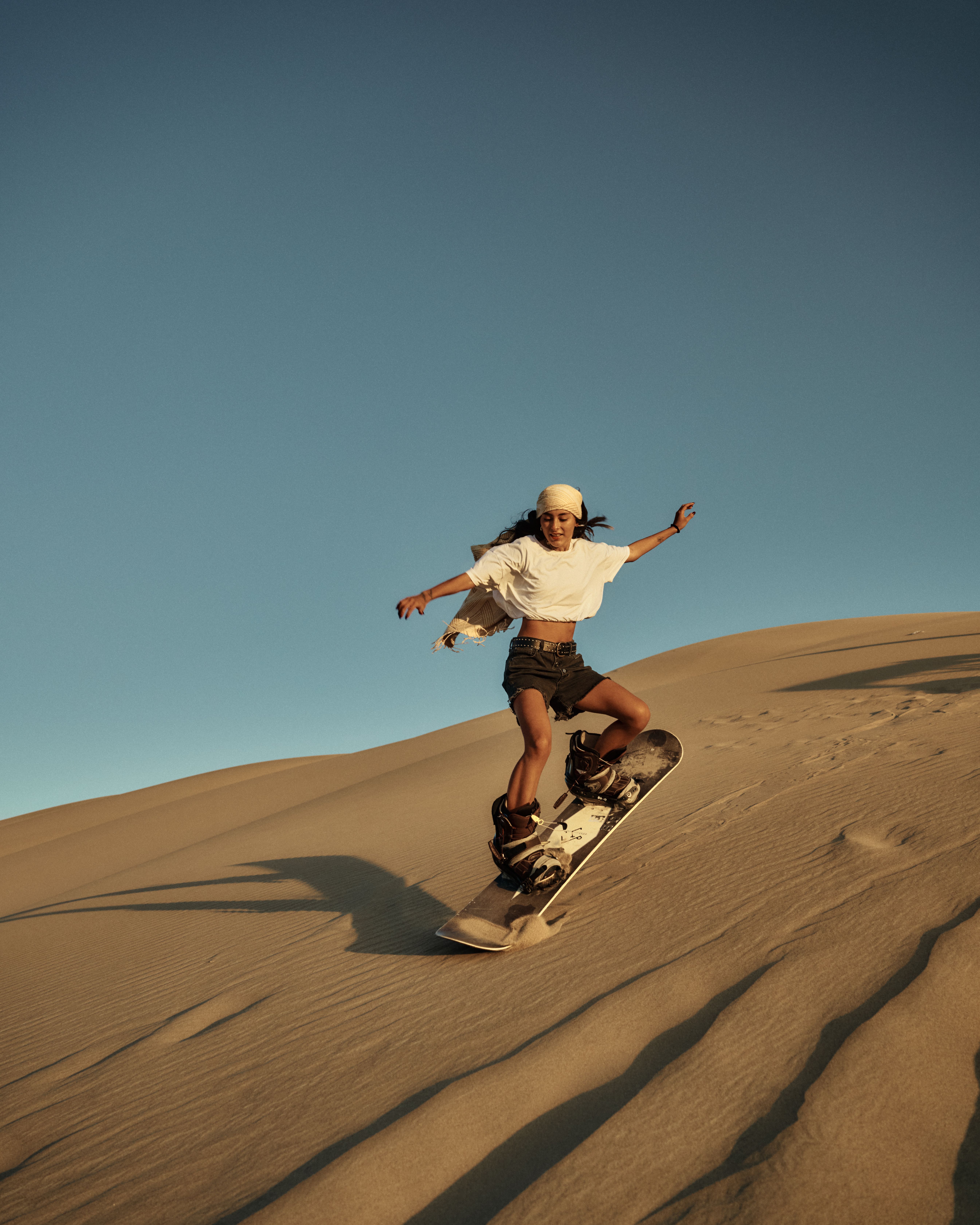 Sandboarding on a desert dune