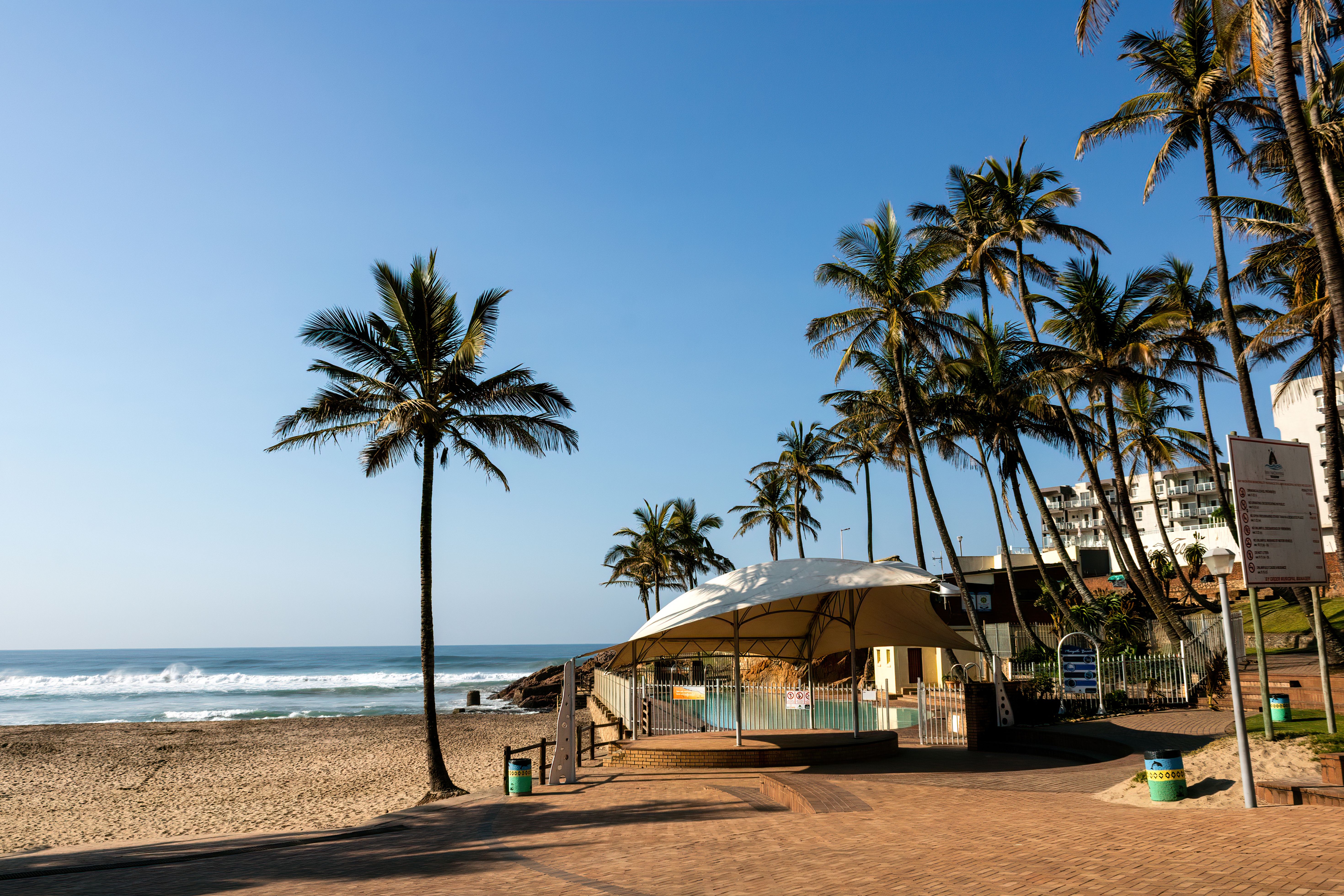 Scenic view of palm trees and structures at Margate Beach, KwaZulu-Natal, South Africa.