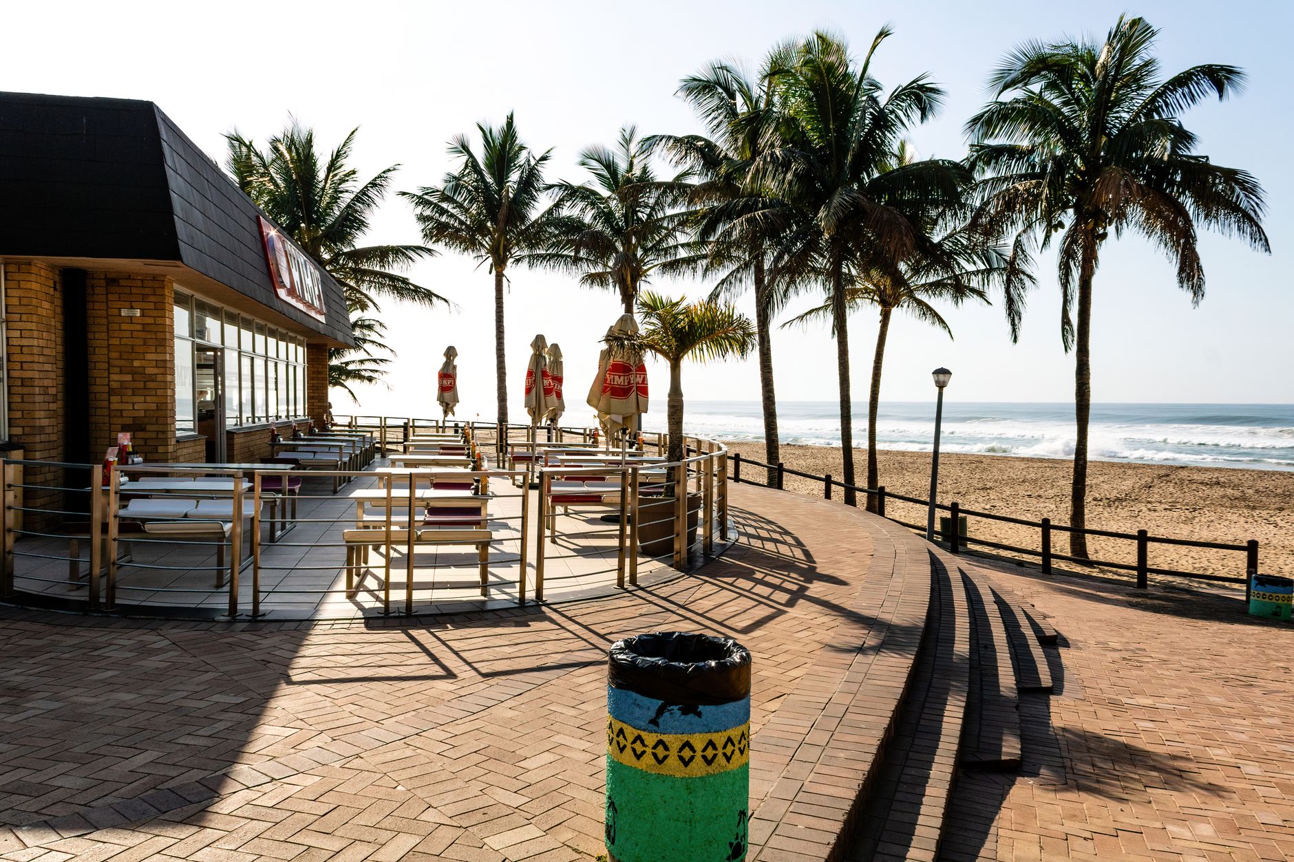 A sunny day at Wimpy beachfront café in Margate, South Africa with ocean and palms.