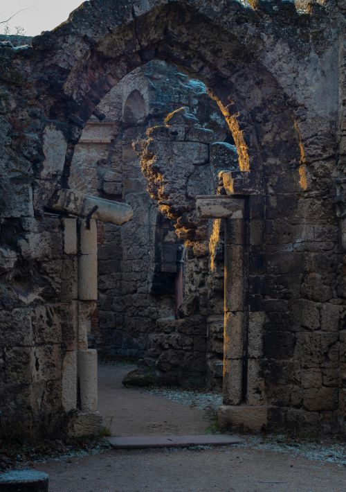 Free Explore ancient stone ruins lit by the warm glow of a sunrise, showcasing historic architecture. Stock Photo