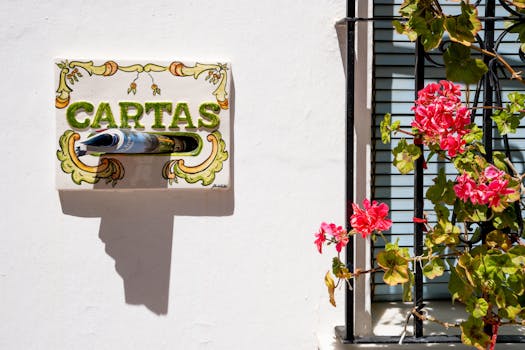 Beautiful white wall with flowers and decorative Spanish mailbox in Benalmádena, Andalucía.