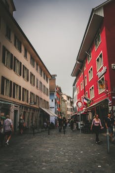 Charming street view in Zürich, Switzerland featuring colorful buildings and lively foot traffic.