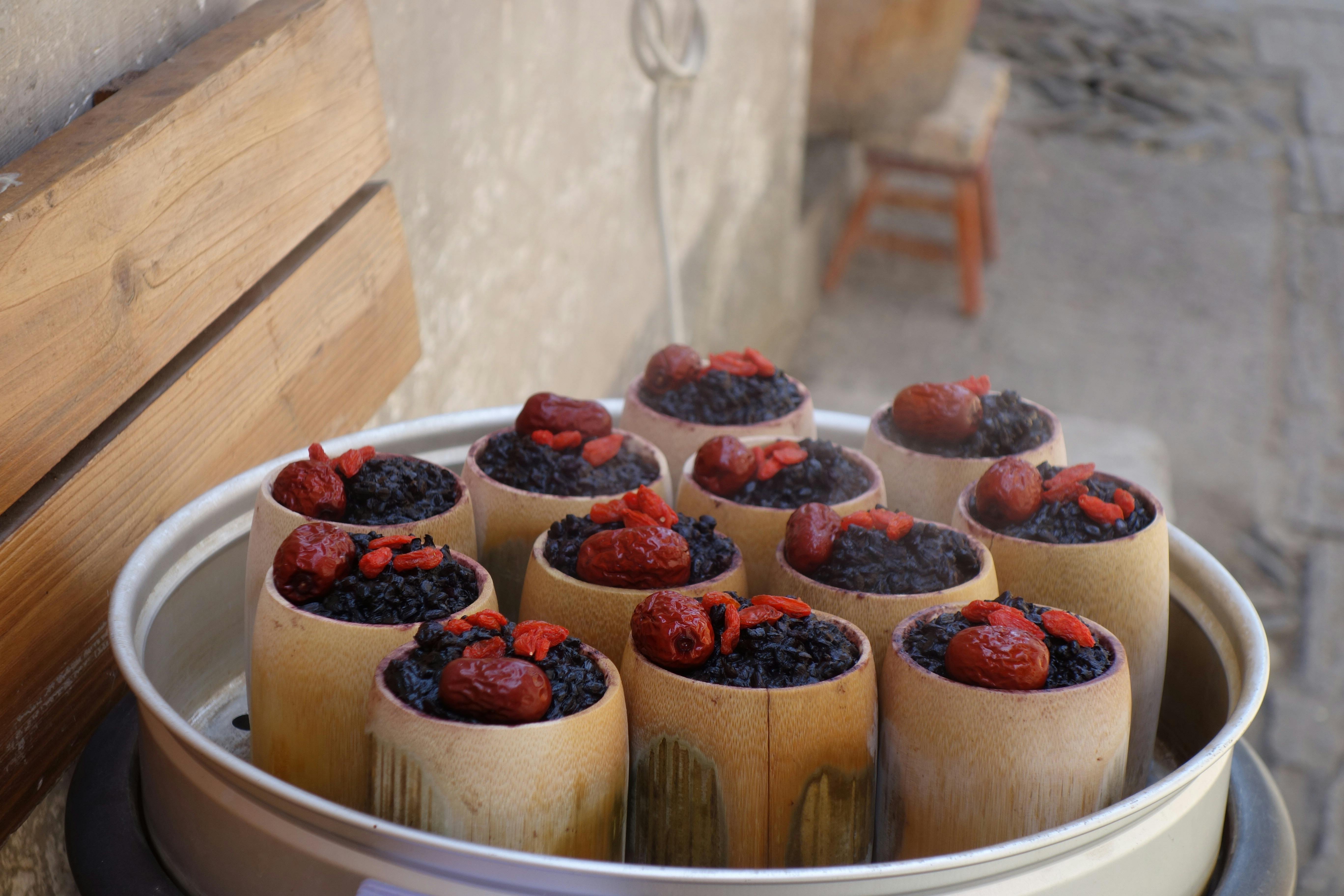 Delicious steamed bamboo rice topped with red dates and goji berries, perfect for culinary exploration.