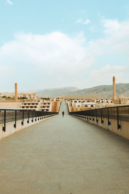 Free Wide view of Hasankeyf's historic bridge with a scenic backdrop, ideal for travel exploration. Stock Photo