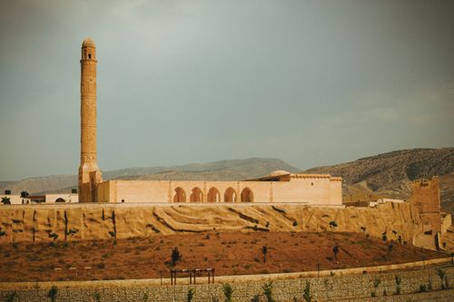 Free Stunning view of a historic minaret and building in Hasankeyf, Turkey, under a clear sky. Stock Photo