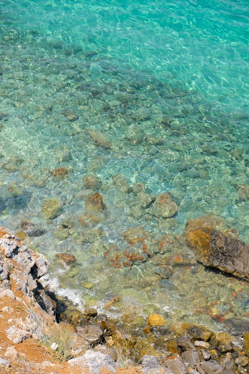 Free Crystal-clear turquoise waters with rocks near the shore in Aydın, Türkiye. Stock Photo