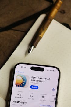 Close-up of a smartphone displaying an educational app in Russian on a table.