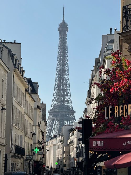 Free Scenic view of the Eiffel Tower from a classic Parisian street, capturing urban charm and iconic architecture. Stock Photo