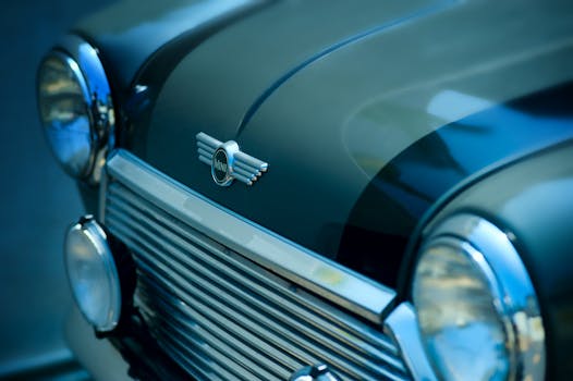 Close-up view of a vintage Mini Cooper front, showcasing its classic design and chrome details.
