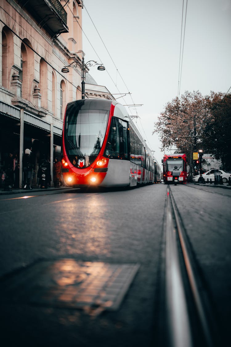 Tram Riding On City Street Near Buildings