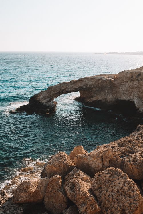 Free Beautiful rocky coastal arch near clear blue sea in Cyprus during summer. Stock Photo