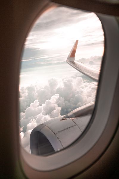 View of clouds from an aircraft window — photo by Alex Azabache on Pexels