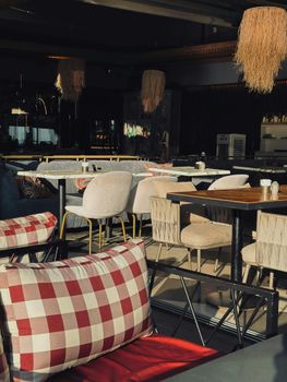 Warm interior of a modern restaurant with stylish furniture and soft lighting ambiance.