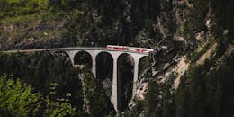 Red Train on Scenic Swiss Viaduct in Alps