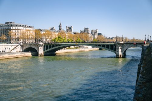 Free Stunning view of a historic Parisian bridge crossing the Seine, capturing the architectural beauty of Paris. Stock Photo
