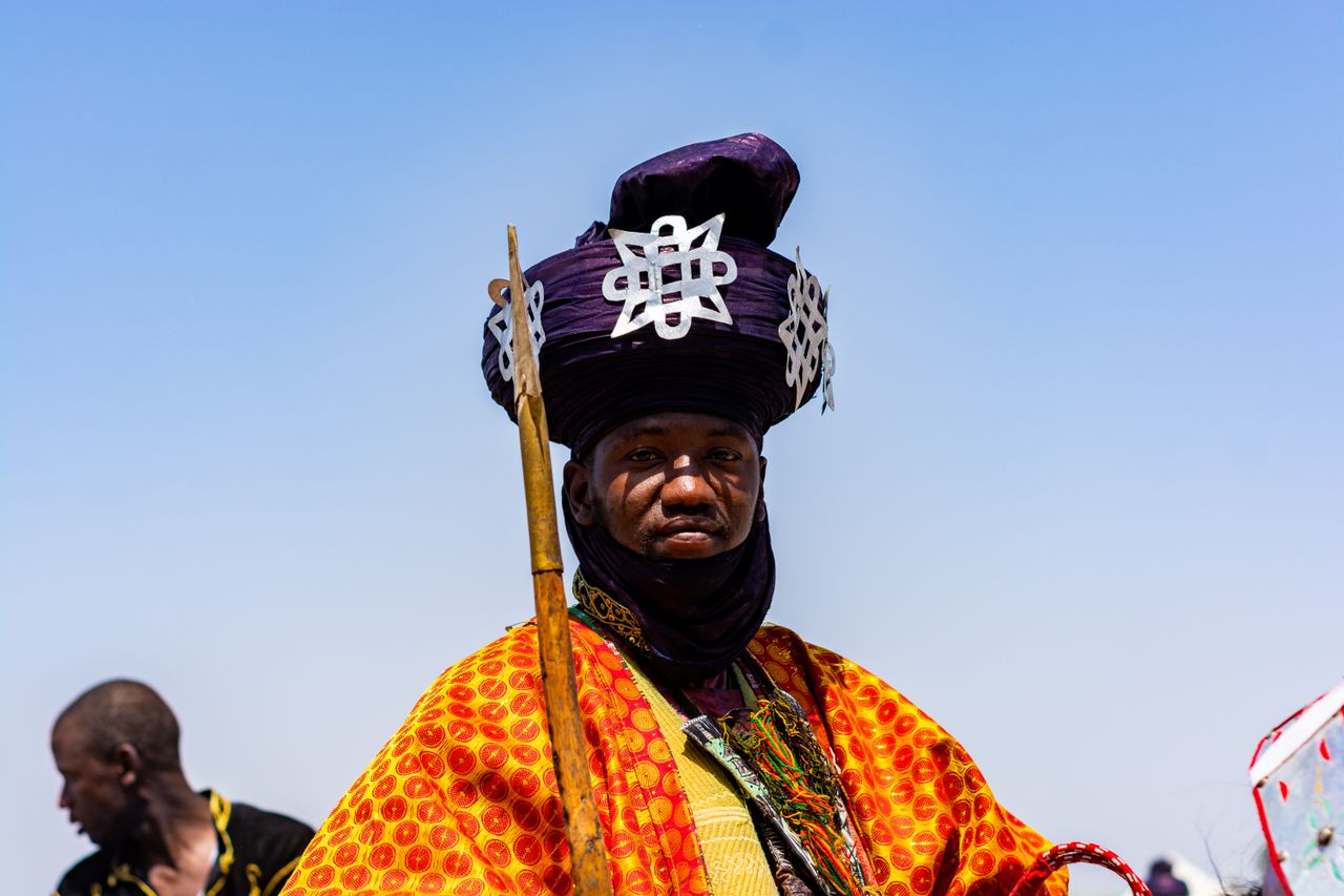 portrait of a man in vibrant traditional african attire during a cultu