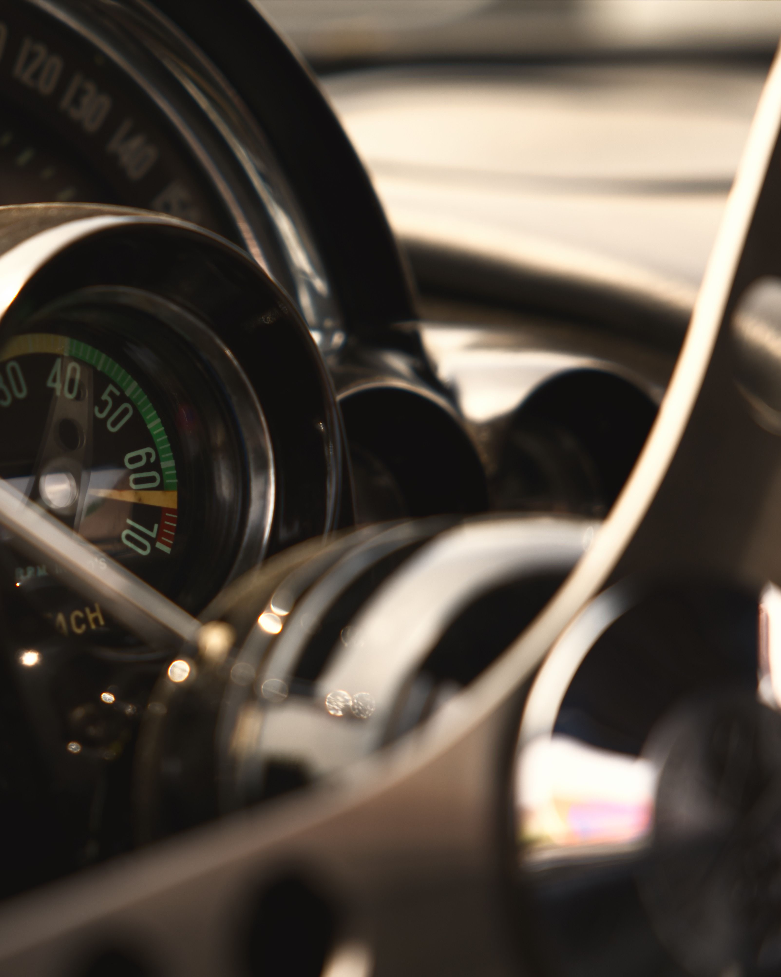 Close-up of a vintage car dashboard featuring classic gauges and a retro design.
