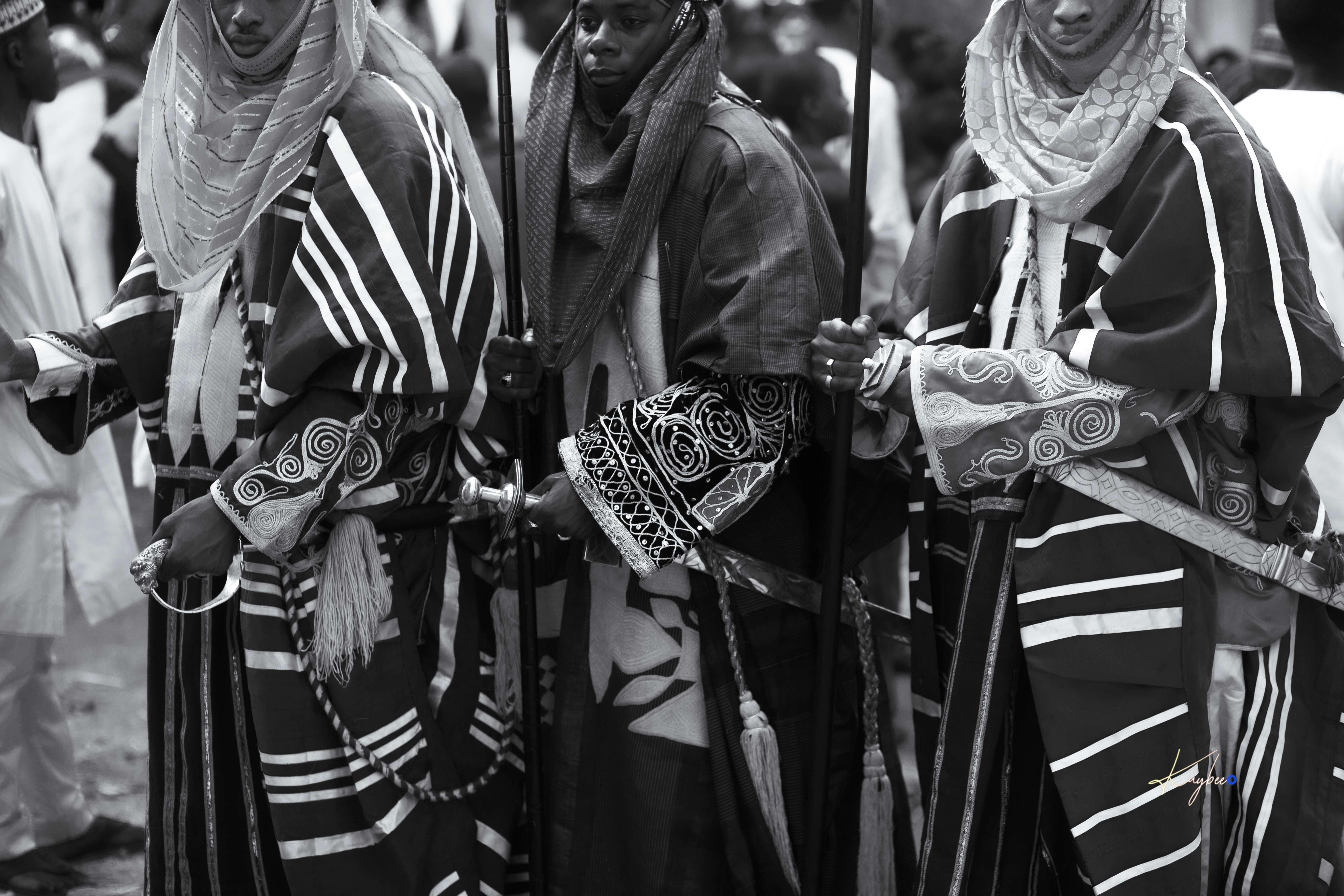 Group of people in traditional African clothing at cultural event.