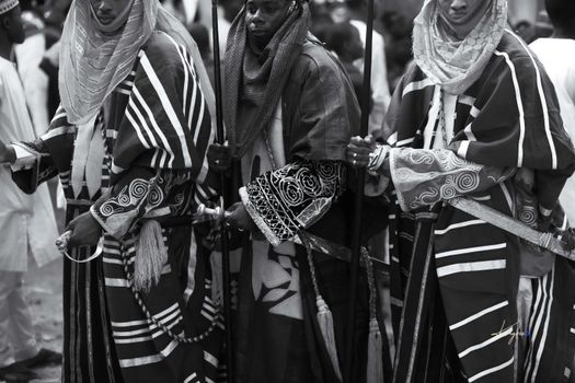 Group of people in traditional African clothing at cultural event.