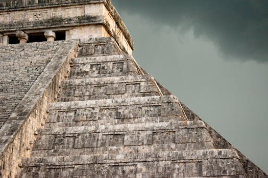 Close-up of the El Castillo pyramid at Chichén Itzá with stormy sky.