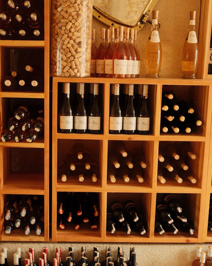 Wine bottles stored in a wooden rack, similar to a wine cooler setup Wine bottles stored in a wooden rack, similar to a wine cooler setup