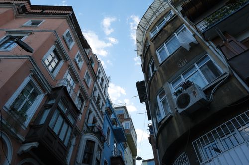 Free Low angle view of quaint, colorful European buildings against the sunny sky. Stock Photo