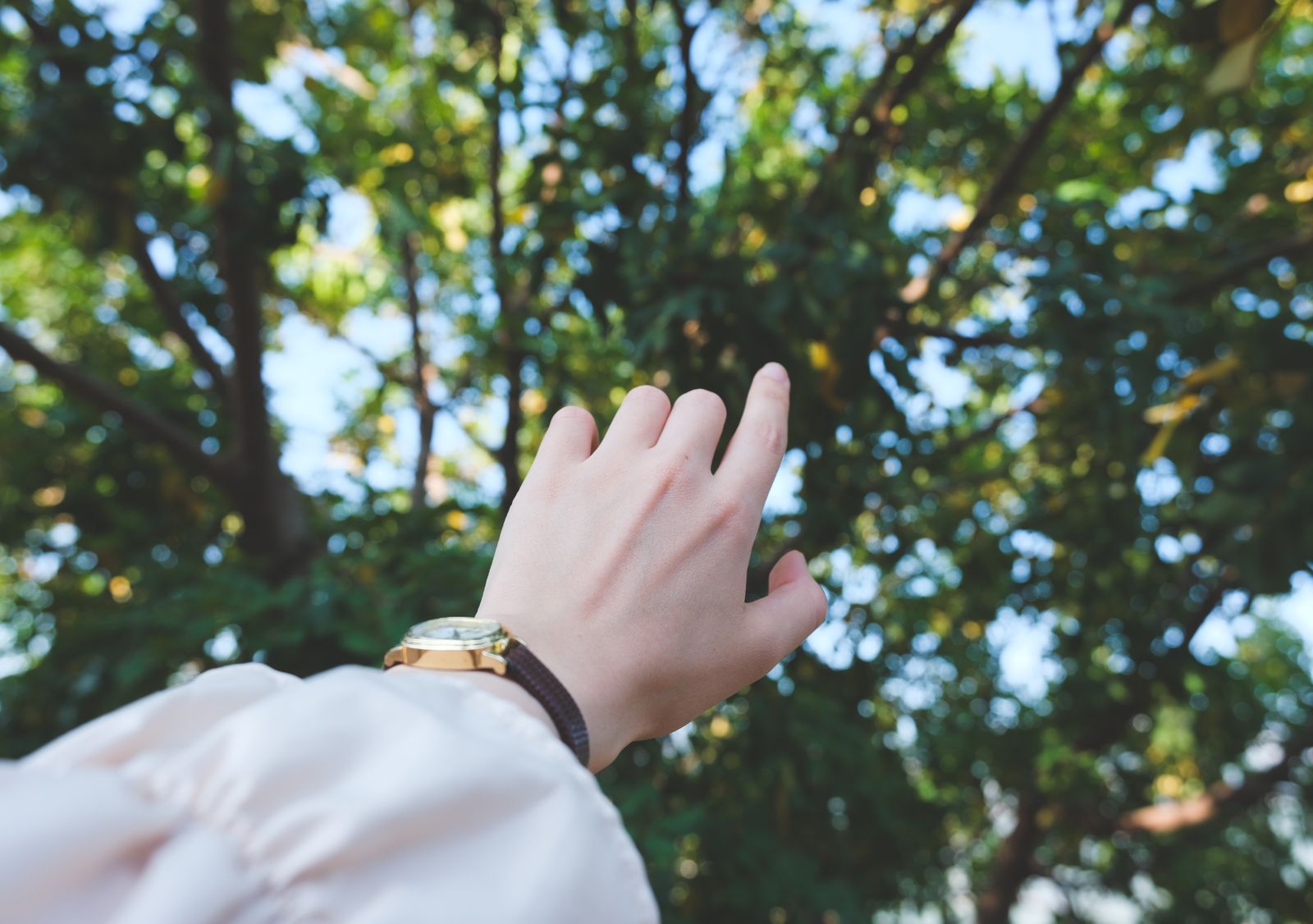 Person adjusting a wrist and thumb support in bright daylight